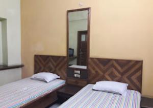 RourkelaHotel Solan Rourkela的一间卧室配有两张床和镜子