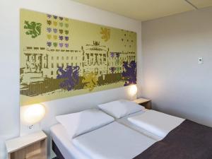 布伦瑞克布伦瑞克北B＆B酒店的卧室配有一张床,墙上挂有绘画作品