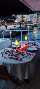 伊斯坦布尔PRUVA YACHT的船上的一张桌子,上面放着蜡烛和玫瑰