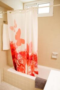 贝纳尔马德纳Apartamento Tamarindos II的浴室设有淋浴帘和蝴蝶。
