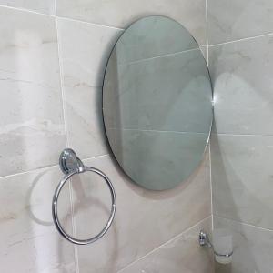 阿瓜奇卡HOTEL LUZ MERY的浴室墙上的圆镜子