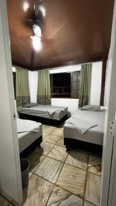 维多利亚Sossai Hostel的带三张床和天花板的客房