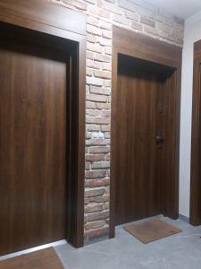 比得哥什Apartamenty Jaskółcza的砖墙房间的两个门