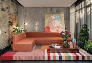 基辅BURSA Hotel Kyiv的客厅配有橙色沙发和绘画