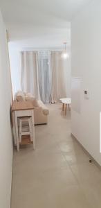 卢恰纳L'albizia Studio calme et tout confort的白色的客厅配有沙发和桌子