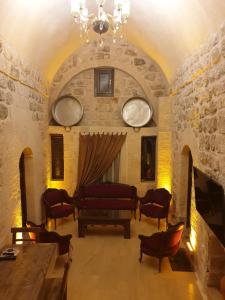 马尔丁Mardin tarihi ulu Cami yanı, tarihi Konak的客厅配有沙发和桌椅