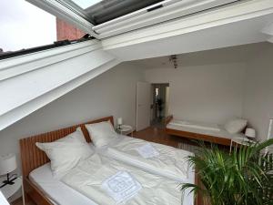 美因河畔法兰克福GardenApartment的阁楼卧室设有床和窗户。