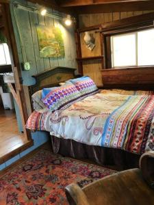 RochesterThe Hunter Cabin at Sky Hollow的一间卧室,卧室内配有一张床和一把椅子