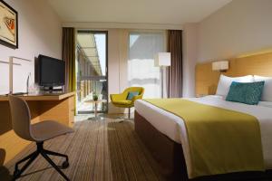 蒙彼利埃蒙彼利埃万怡酒店的酒店客房配有一张床、一张书桌和一台电视。