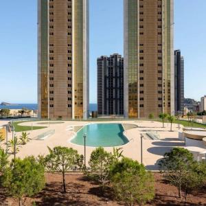 贝尼多姆Intempo Residential Sky Resort & Spa - Benidorm, España的一座游泳池,位于一些高楼前