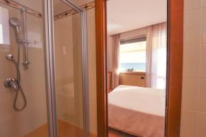 莱里奇佛罗里达莱里奇酒店的带淋浴的浴室和带窗户的床
