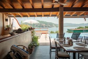 锡瓦塔塔内霍Villa del Pescador的一间带桌椅并享有水景的餐厅