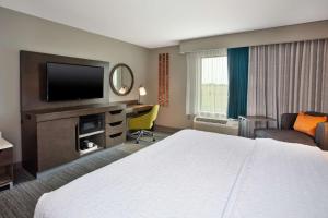 尤宁城Hampton Inn Union City, Tn的配有一张床和一台平面电视的酒店客房