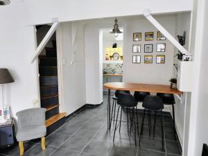 博韦LA PETITE MAISON的厨房以及带桌子和凳子的用餐室。