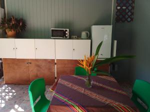 VaïareFare Mihimana的一间带桌子和绿色椅子的用餐室