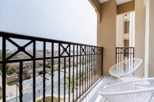 迪拜Nasma Luxury Stays - Fabulous Apartment With Balcony Near MJL's Souk的设有一个配有白色椅子的阳台,享有美景。