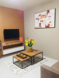 碧瑶Brenthill Condominium的客厅配有咖啡桌和电视
