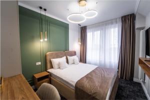 苏恰瓦匝姆卡苏恰瓦酒店的一间卧室设有一张床和绿色的墙壁