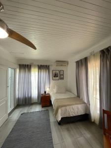内尔斯普雷特Groenewald's Haven的一间卧室配有床和带窗帘的窗户