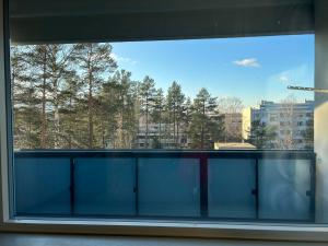 赫尔辛基An entire flat 60m2 with a balcony in Itakeskus of Helsinki的窗户,享有树林美景