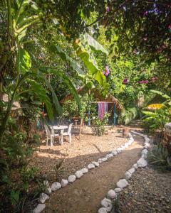 帕洛米诺Palomino EcoHouse & Camping的树下带桌椅的花园