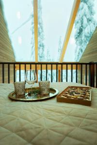 索特Villa Auroras Karhu的一张桌子,上面放着一盘食物和一杯葡萄酒
