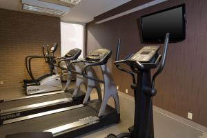 尚佩恩德鲁里香槟套房酒店 的健身房设有3台跑步机和1台平面电视