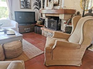 卡尔德斯德马拉维亚Casa Caldes de Malavella, 5 dormitorios, 10 personas - ES-209-37的客厅配有椅子和壁炉