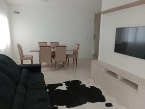 邦比尼亚斯Apto canto grande Bombinhas的客厅配有沙发和桌椅
