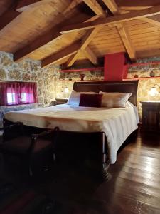 塞尼梅西奇卡罗Ξενώνας Λίκνο的一间带一张大床的卧室,位于一个拥有木制天花板的房间