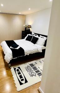 伦敦Luxury Modern Canary 1 bedroom Apartment的一间卧室配有一张大床,提供黑白枕头
