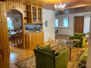 塔林Cozy home in Tallinn的客厅配有绿色椅子和桌子