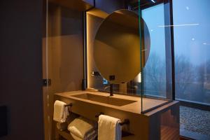 SaludecioLe Agavi Resort & SPA的一间带大镜子的盥洗盆的浴室