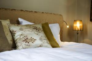 克里斯蒂娜港索克斯洛特酒店的一张带白色床单和枕头的床,配有台灯
