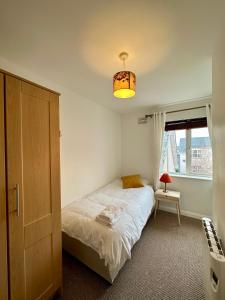 沃特福德Stunning City Centre Apartments的一间小卧室,配有一张床和一个光线