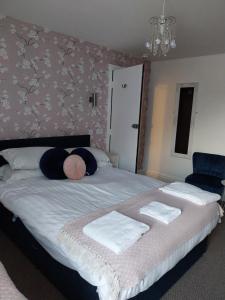 布莱克浦Delamere Hotel的一间卧室配有一张大床和毛巾
