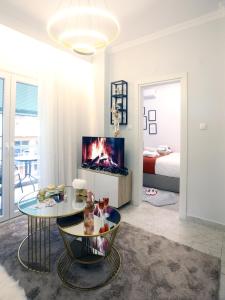塞萨洛尼基Psimithefto Luxury Apartments的带壁炉的客厅和卧室