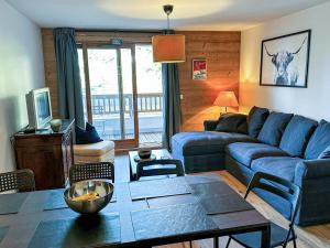 瓦尔莫雷尔Appartement Valmorel, 3 pièces, 7 personnes - FR-1-356-414的客厅配有蓝色的沙发和桌子