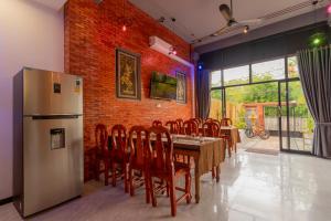 Phumĭ Ta PhŭlAngkor Rithy Residences的一间带桌子和冰箱的用餐室