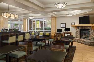爱达荷福尔斯La Quinta by Wyndham Idaho Falls/Ammon的一间带桌椅和壁炉的餐厅