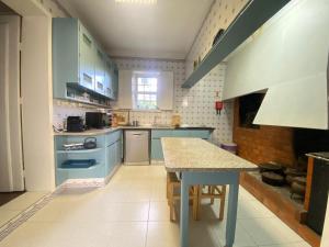 拜昂Casa da Ponte的厨房配有蓝色橱柜和桌子