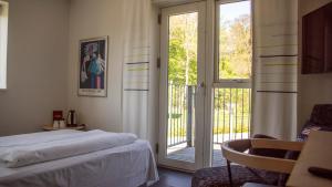 斯基沃阿特瑞德坦根酒店的一间卧室设有一张床和一个滑动玻璃门