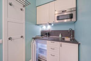 维尔纽斯Station Apartments - Lollo Luxury的小厨房配有白色橱柜和水槽