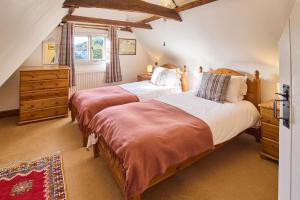 坎特伯雷Host & Stay - Bere Cottage的一间卧室设有两张床和窗户。