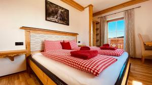 比绍夫斯霍芬Bio Alpenhof Rostatt的一间卧室配有一张带红色枕头的床