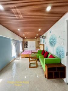 头顿Căn Funny的客厅配有绿色沙发和床。
