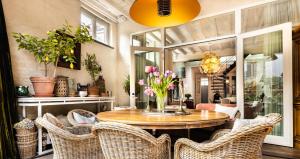 布鲁日Maison Amodio的一间带桌椅和鲜花的用餐室