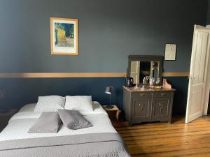 根特瓦康迪罗吉斯法哈洛比旅馆的一间卧室配有一张床和一个带镜子的梳妆台