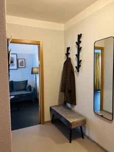 叶卡布皮尔斯Mežaparka apartamenti的一间设有镜子、长凳和沙发的房间
