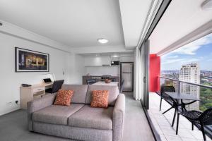 布里斯班Oaks Brisbane on Felix Suites的带沙发的客厅和阳台